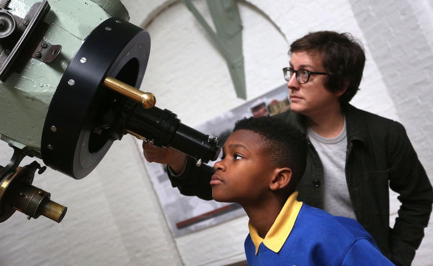 Student and teacher with space telescope