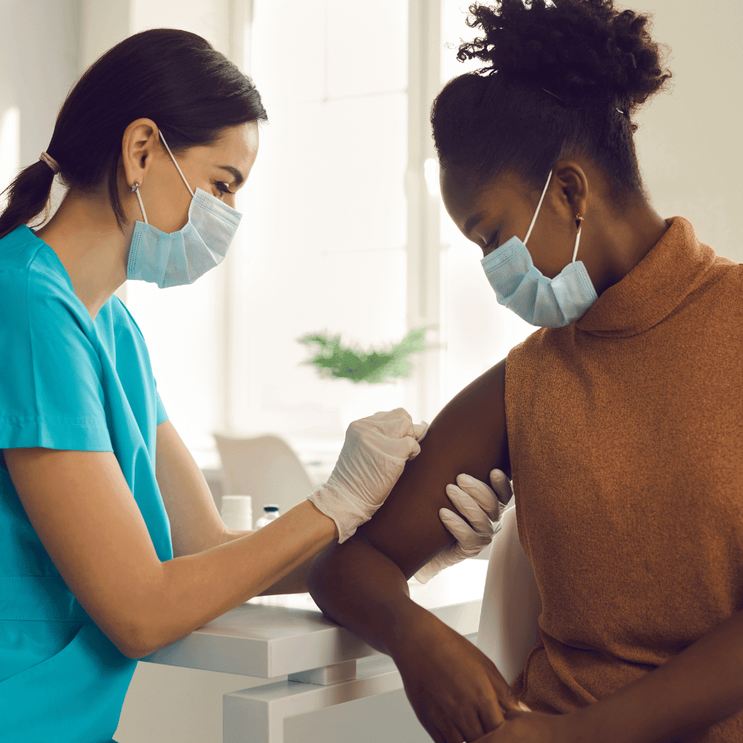 Nurse gives woman vaccine shot
