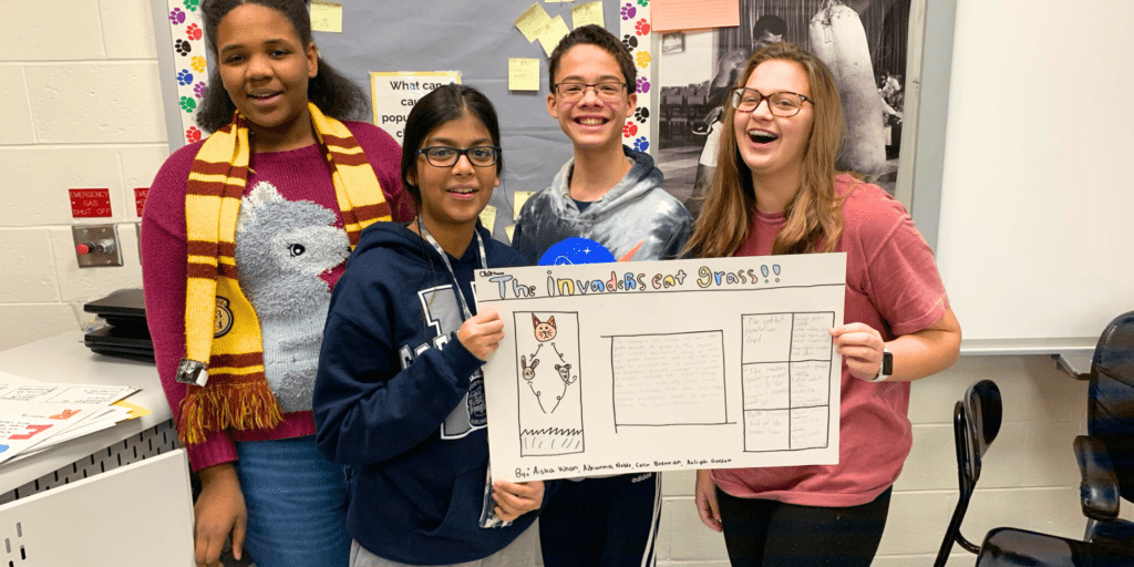 [PHOTO: 7th-grade students at Northern Burlington Middle School celebrate constructing arguments to determine what an invasive species eats. IQWST curriculum. CREDIT: @mrvaranyak/Twitter]